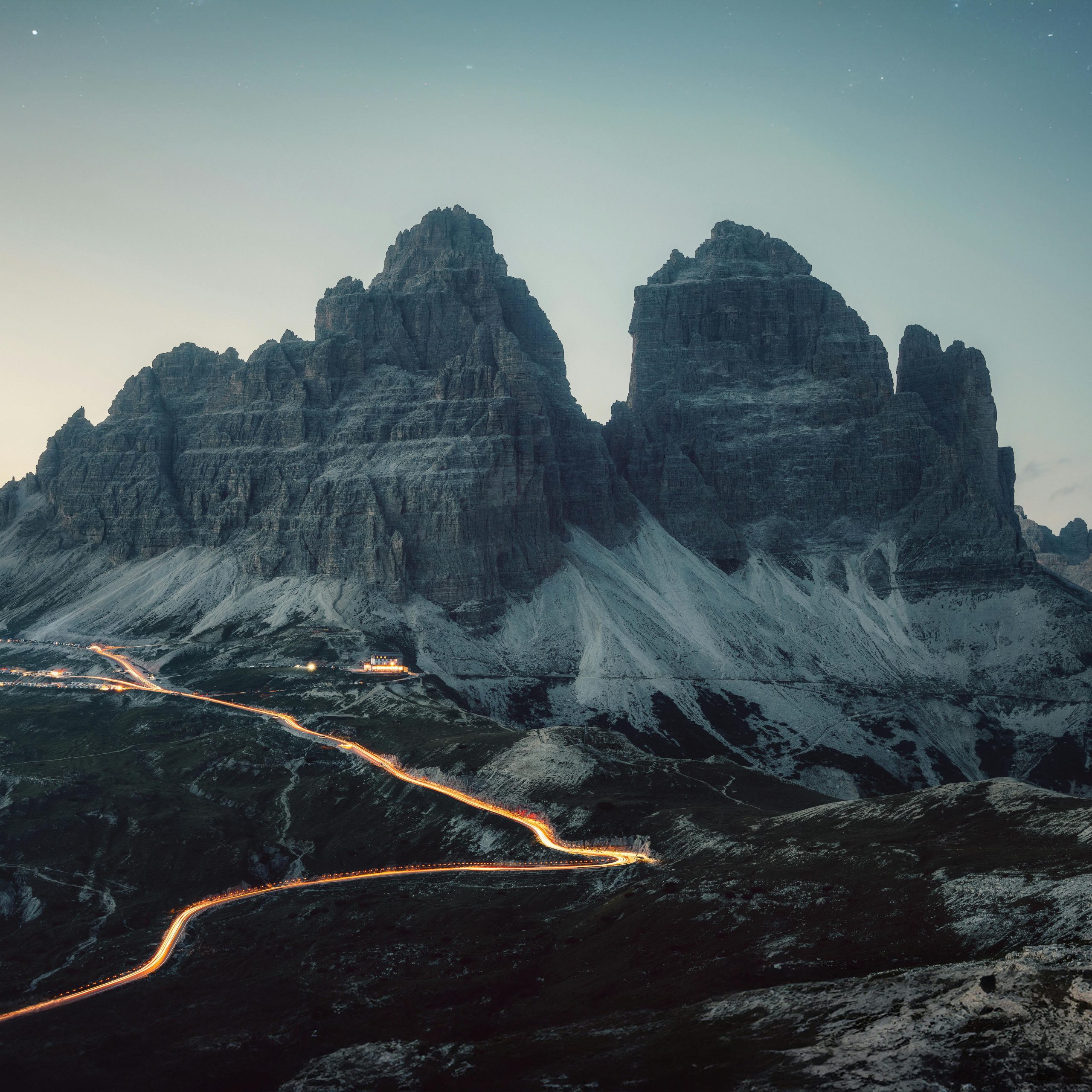 pexels-eberhardgross-28217963-eberhard grossgasteiger snow capped mountain in the evening with a lit road leading up to it